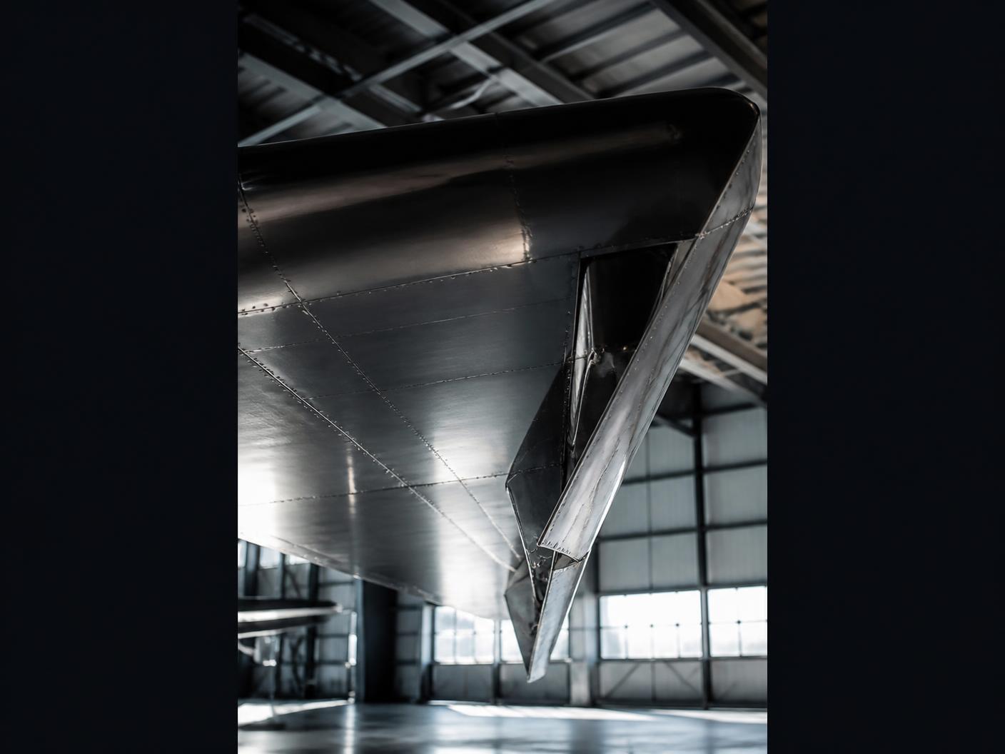 Unbranded aircraft wing detail in an aviation hangar